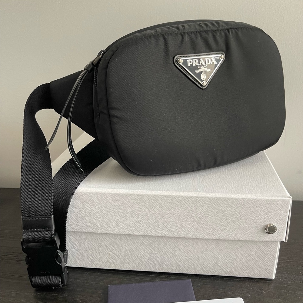 Prada Belt Bag in black with oversized triangle logo and padded detailing.